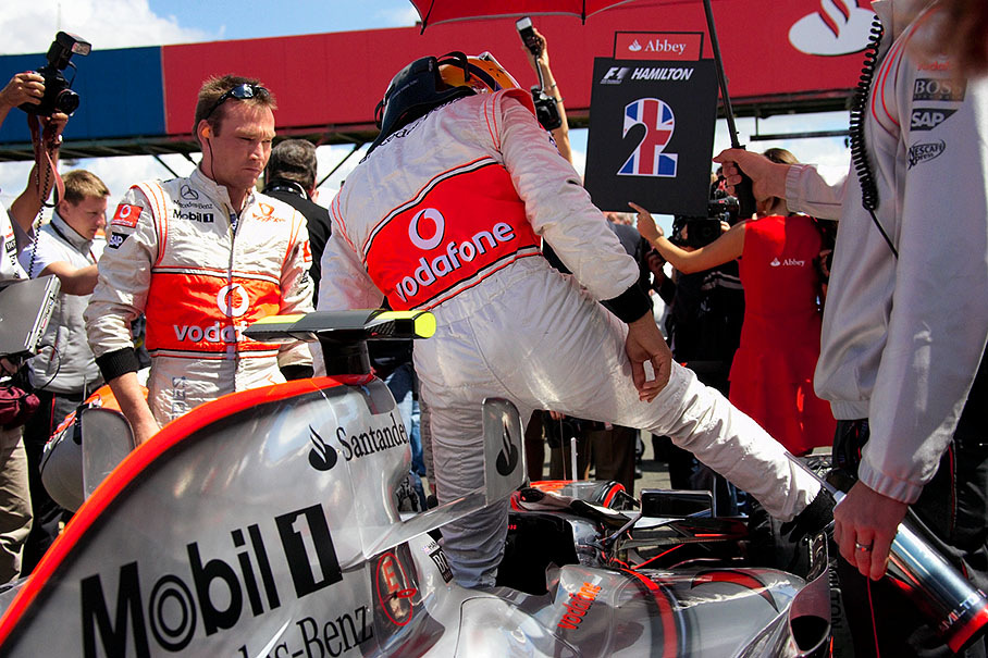 Lewis Hamilton takes place in his cockpit