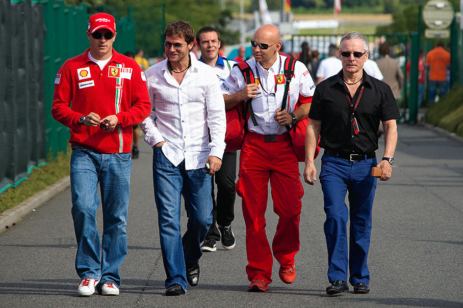 On Friday morning Kimi Raikkonen walks with his managers Steve and David Robertson and his bald physio Mark Arnall