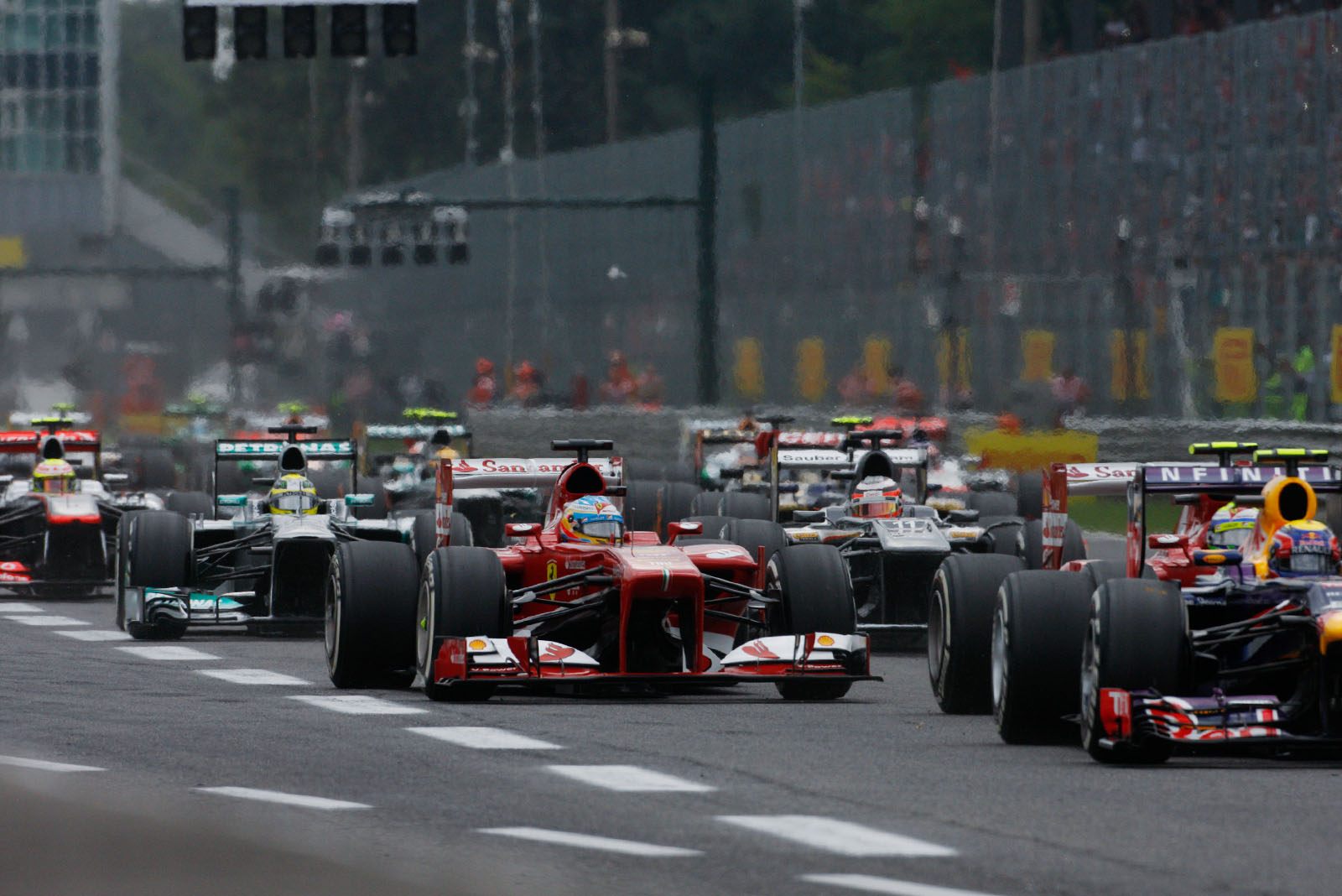 At the start of the Italian Grand Prix, Red Bull's Mark Webber is chased by the two Ferraris