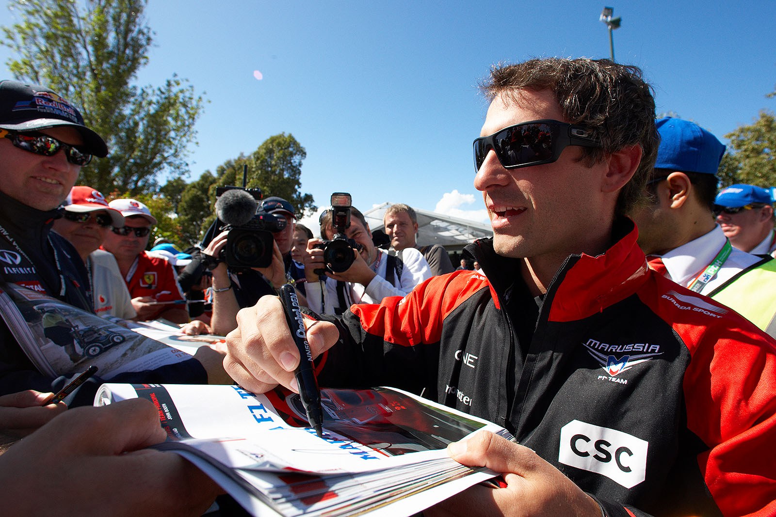 German Timo Glock of Marussia F1 team gives autographs on Sunday morning