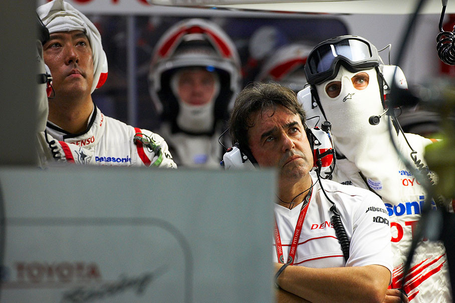Toyota pit crew watchs the race on a screen in pits, the team's medical doctor Ceccarelli
