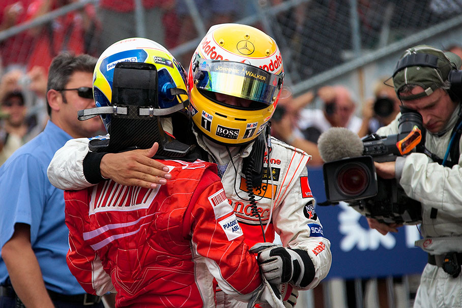 Winner Lewis Hamilton caresses third placed Felipe Massa in parc fermé