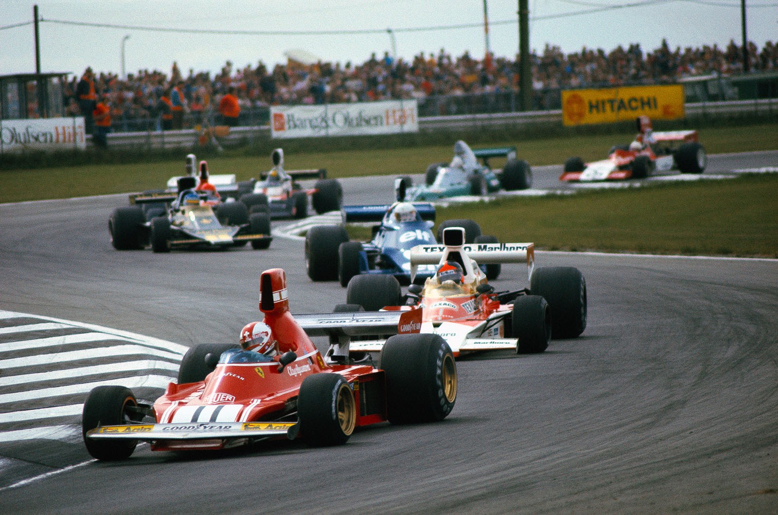 2nd lap of the 1974 Belgian Grand Prix at Nivelle: Race leader and polesetter Clay Regazzoni, Ferrari 312B3, closely followed by Fittipaldi (McLaren) and Scheckter (Tyrrell). Behind them performing a nice drift is Lotus driver Peterson, under pressure from Lauda, Hunt and Pace.