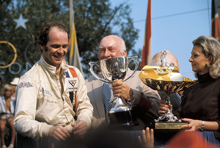 Race winner Peter Gethin celebrates his achievement on the podium