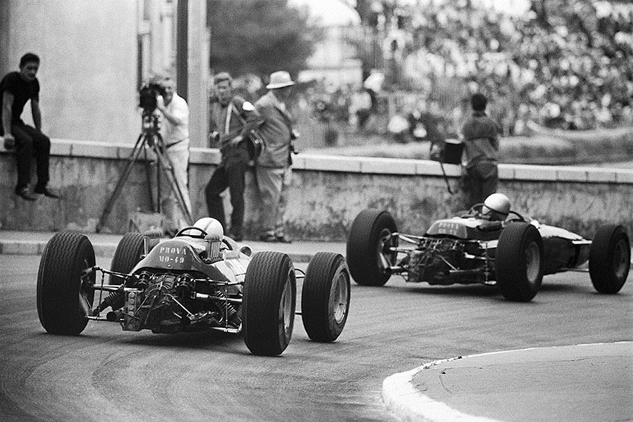 John Surtees follows his team mate Lorenzo Bandini. Surtees drives a Ferrari 158 V8, whilst Bandini is powered by an F12 Typo 1512