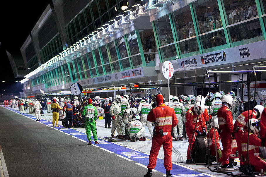 With pitlane still closed, all team's mechanics get ready for the yellow phase pitstop rush