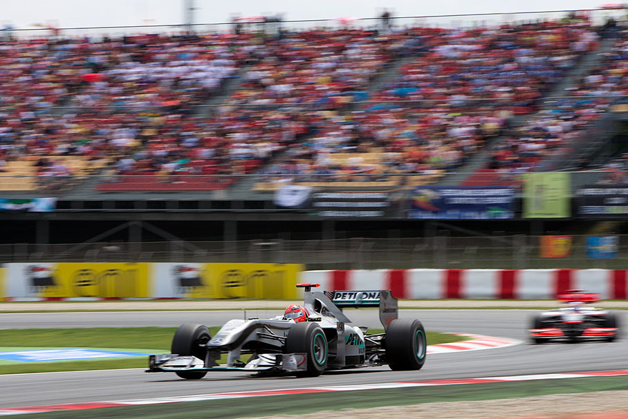 Michael Schumacher, Mercedes GP, in front of McLaren's Button