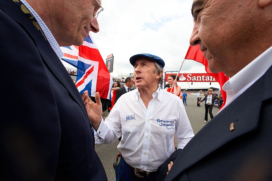 Sir Jackie Stewart talks with honoury guests on the grid
