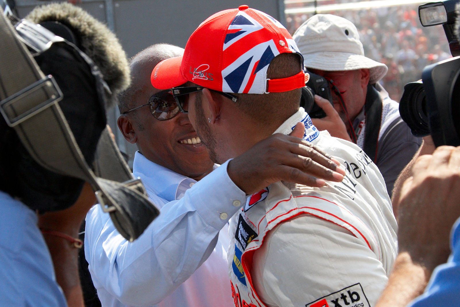 Lewis Hamilton of McLaren receives congrats from his father Anthony for achieving pole position on Hungary's grid