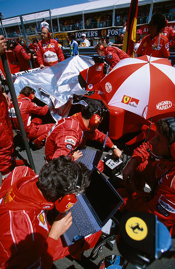 Ferrari mechanics at work on the grid