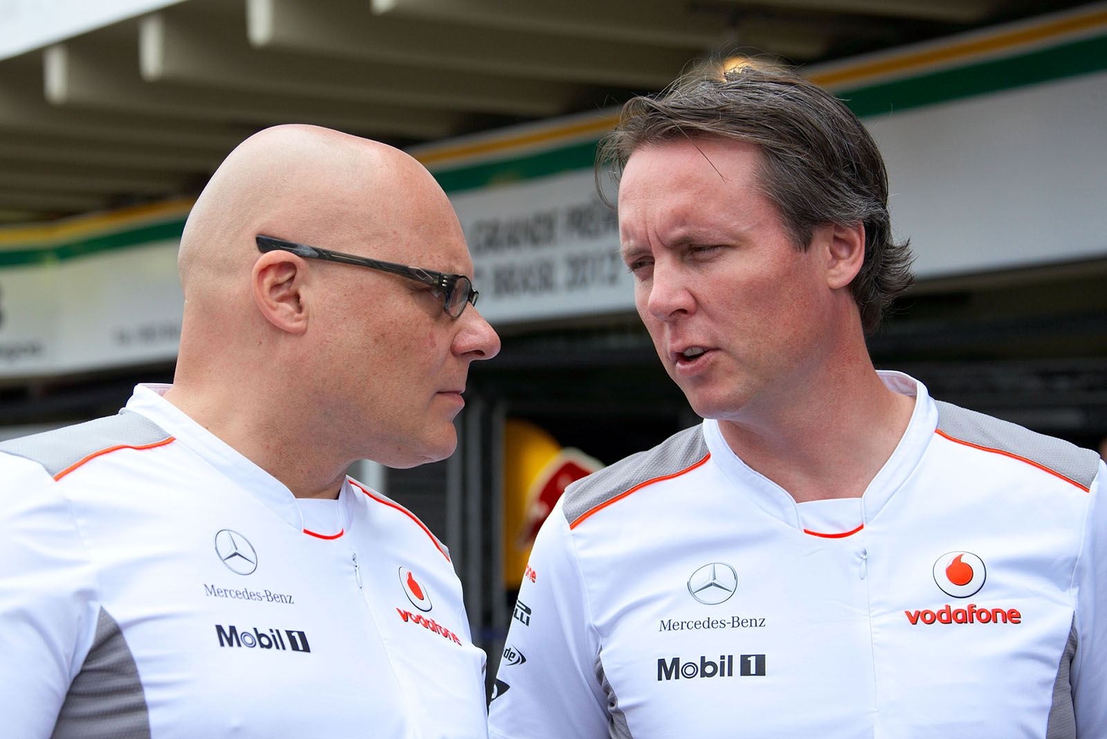 McLaren's head of communications Matt Bishop listens to sporting director Sam Michael