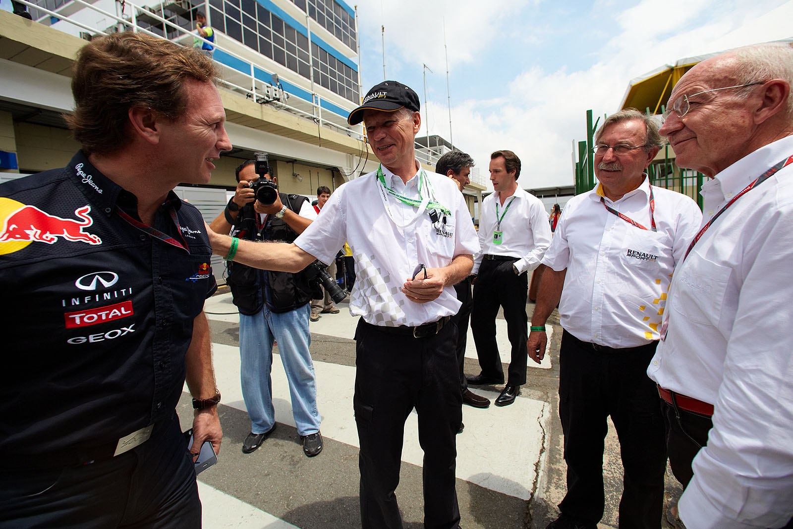 Red Bull team boss Christian Horner says hello to Jean-François Caubet, now managing director of Renault Sport F1 (second from right), with other accompaigning Renault VIPs