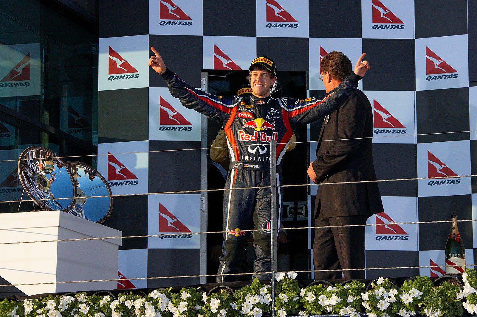 Happy sunnyboy Vettel cheers from podium