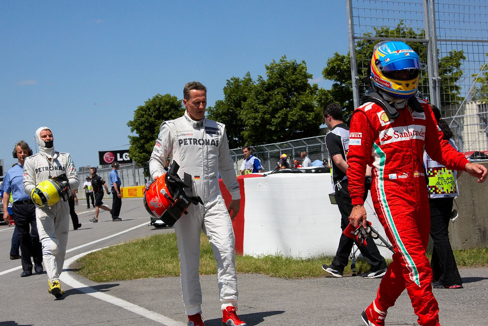 Three drivers walk to the FIA scales after qualifying - Fernando Alonso, Michael Schumacher and Nico Rosberg