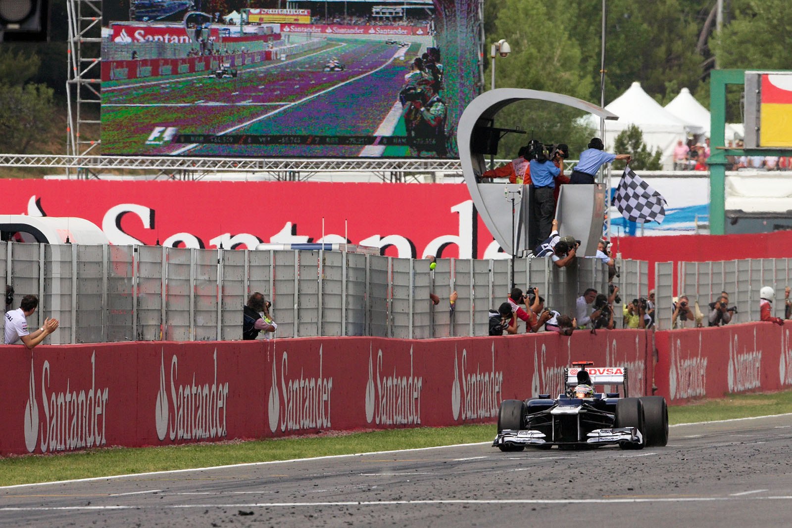 Race winner Pastor Maldonado of Williams takes the chequered flag to win the Spanish Grand Prix, 2012