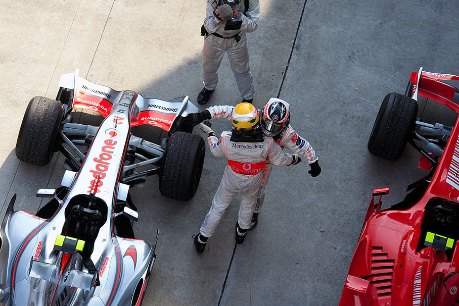 Drunk with joy and success, Alonso and Hamilton embrace each other in parc fermé