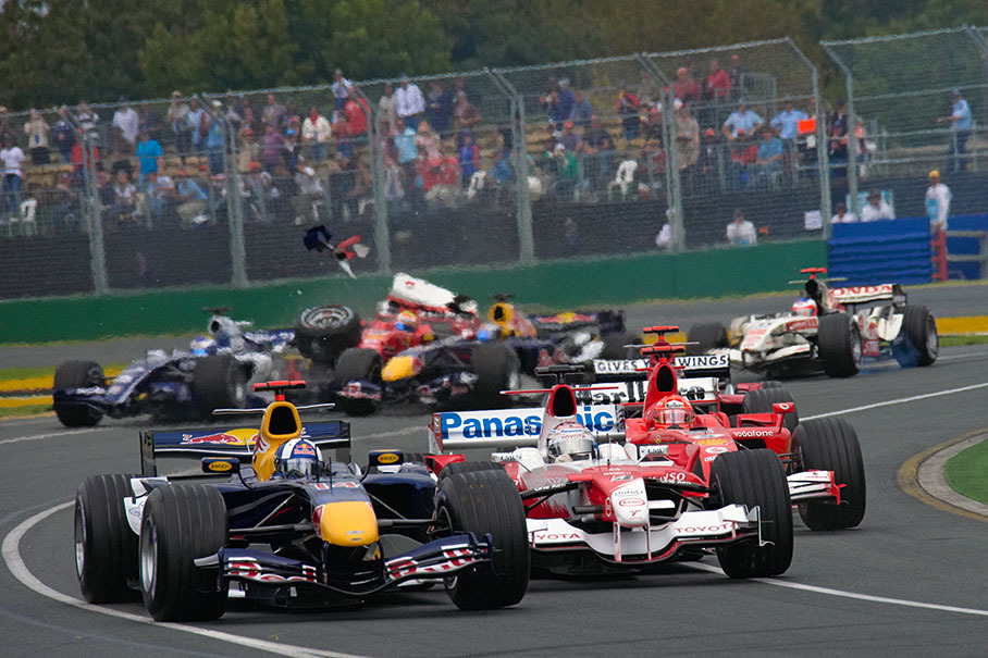 David Coulthard and Jarno Trulli squeezing into chicane exit, escaping the incident behind them
