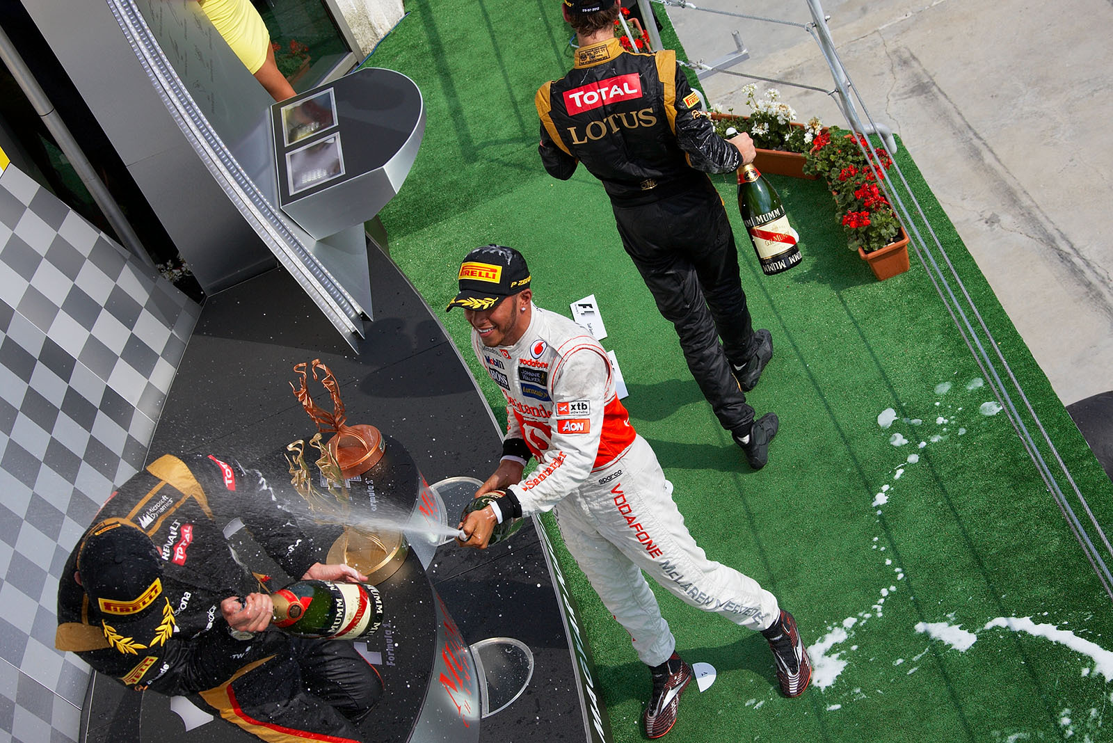 Race winner Lewis Hamilton of McLaren sprays champagne on the podium after the Hungarian Grand Prix