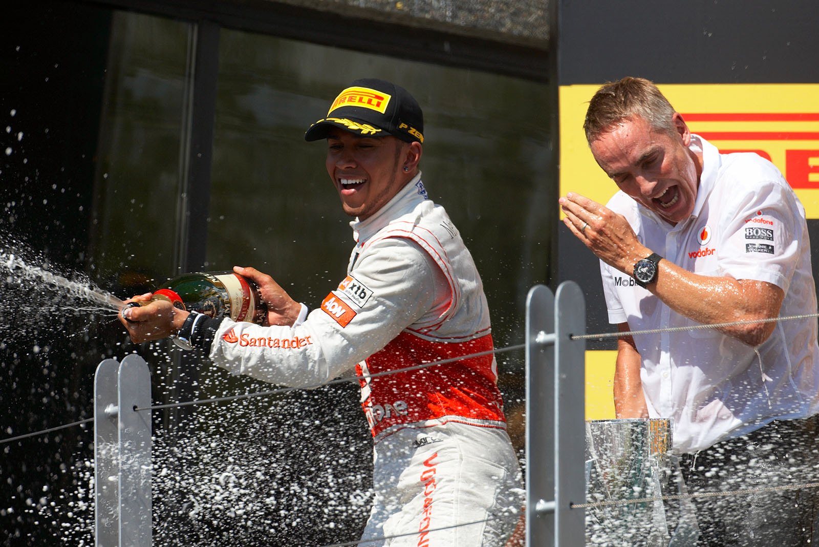 Race winner Lewis Hamilton of McLaren Mercedes sprays champagne from the podium