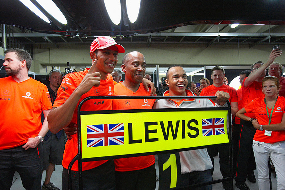 Lewis Hamilton, his father Anthony and brother Nicolas celebrate Lewis' new car number