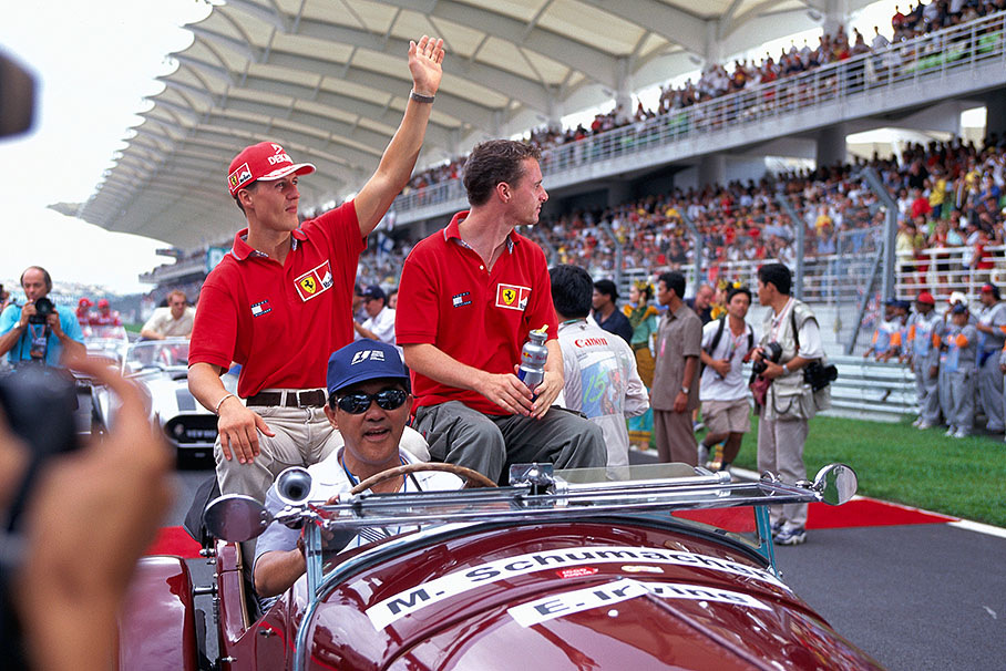 Ferrari drivers Michael Schumacher and Eddie Irvine at the drivers parade lap before the start of the Malaysian GP 1999