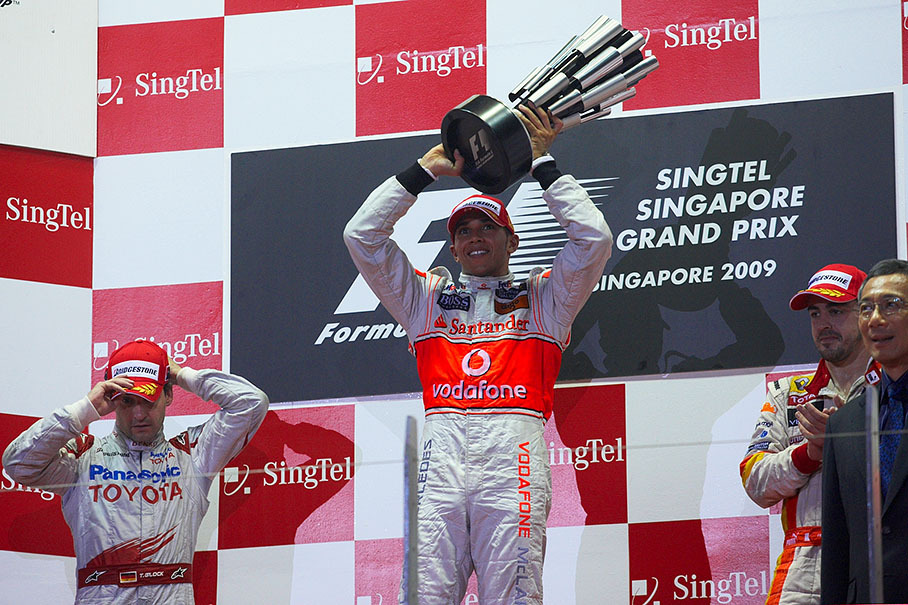 Race winner Lewis Hamilton raises his trophy