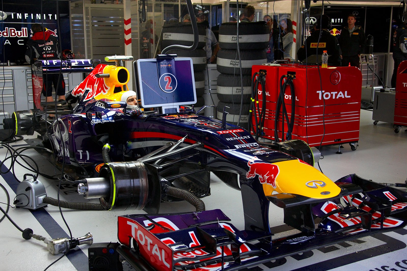 Mark Webber awaits the end of the rain in Red Bull Racing pits