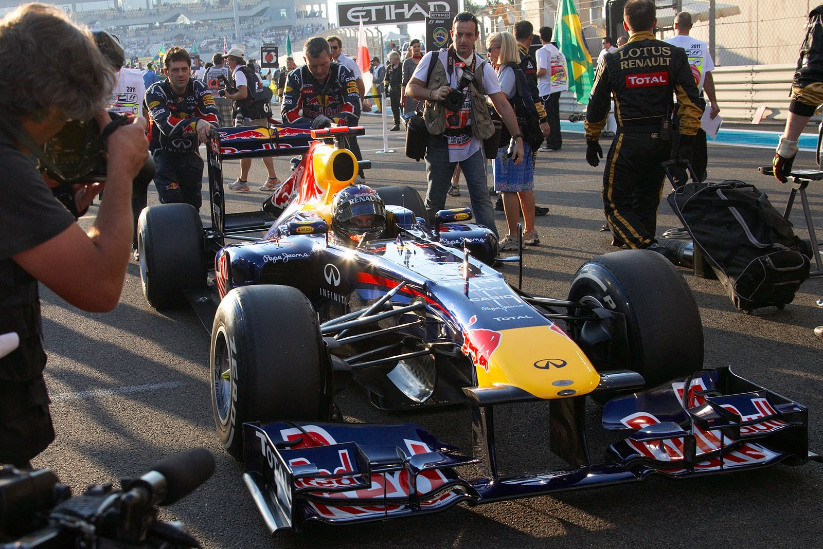 Polesitter Sebastian Vettel of Red Bull Racing is pushed to his grid position