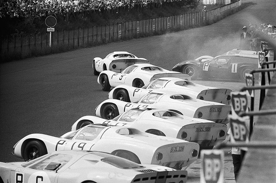Jo Siffert is fast away at the Le Mans-type start at the 1000kms Nuerburgring 1965, leading a whole phalanx of works Porsches