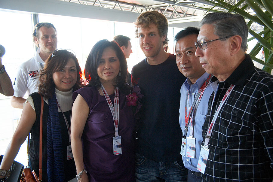 Sebastian Vettel poses for a group photo with family and friends of Red Bull majority owner Chaleo Yoovidhya (second from right hand)