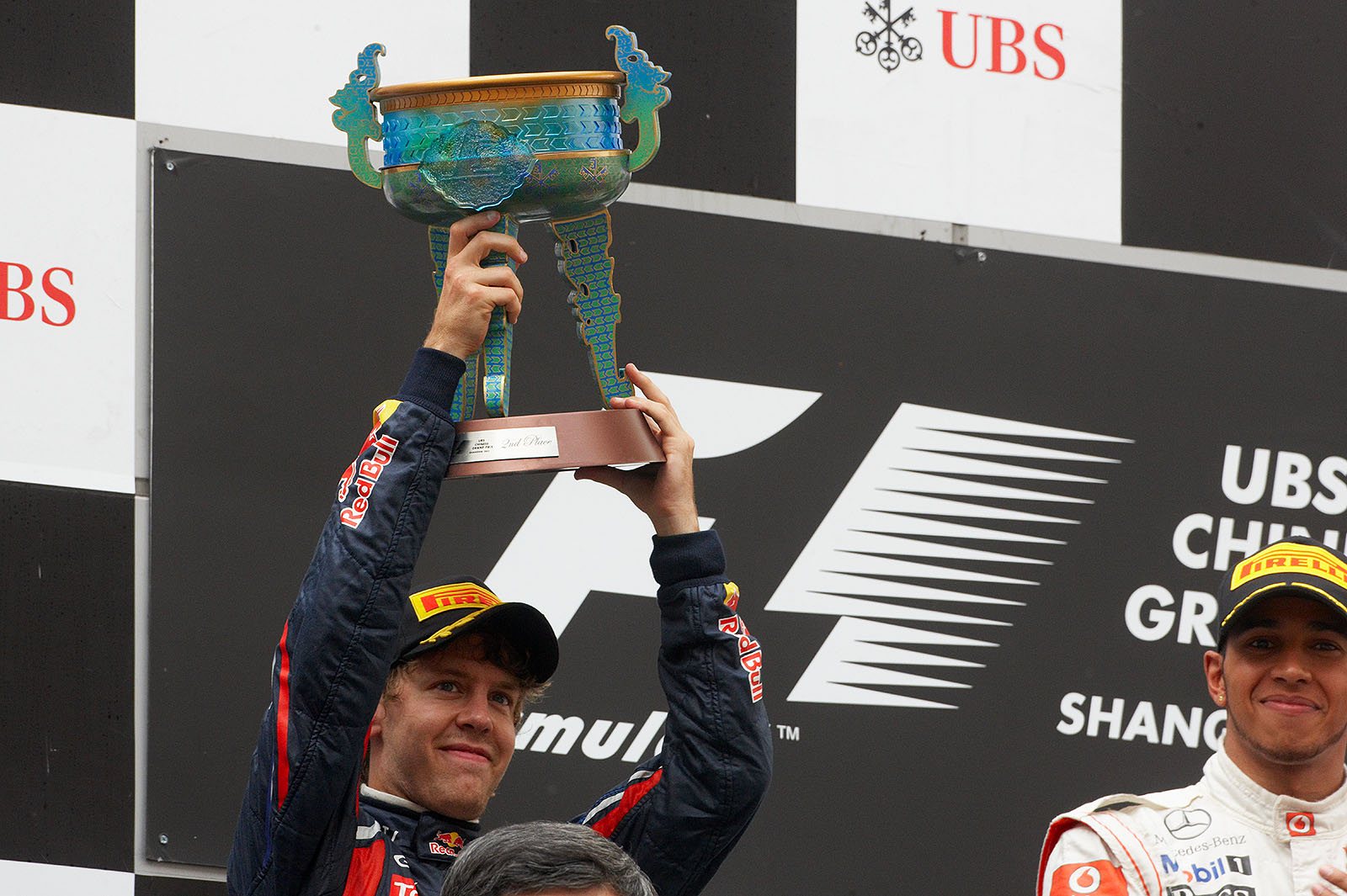 Red Bull's Sebastian Vettel presents his trophy for second place after the Chinese GP