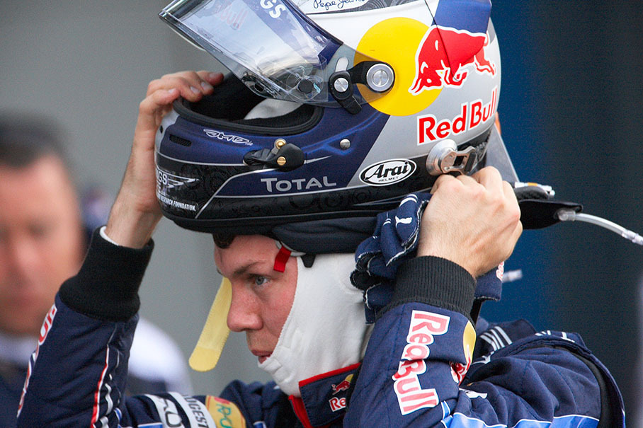 Sebastian Vettel takes his helmet off