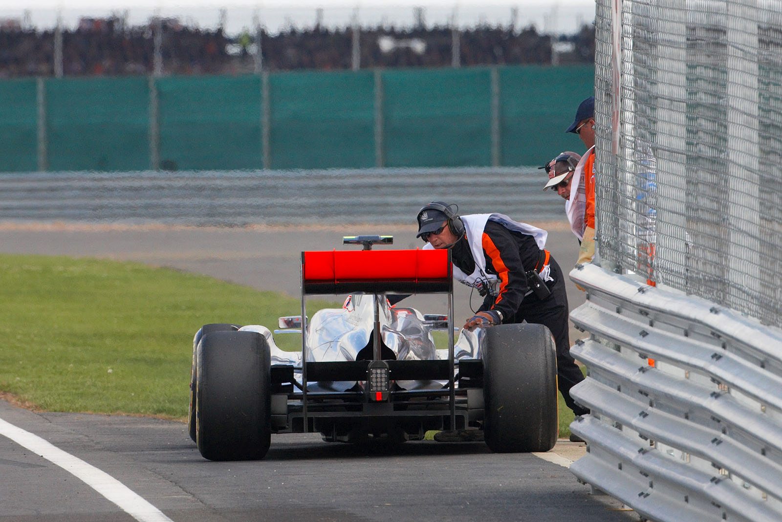 Jenson Button stops at pit lane exit because of a loose wheel nut