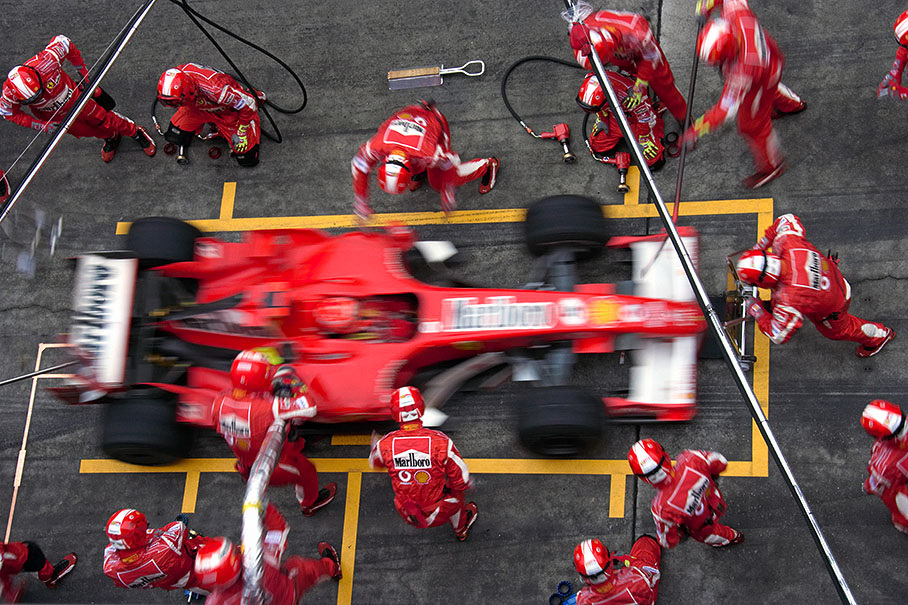 Michael Schumacher performing his first pit stop in lap 21