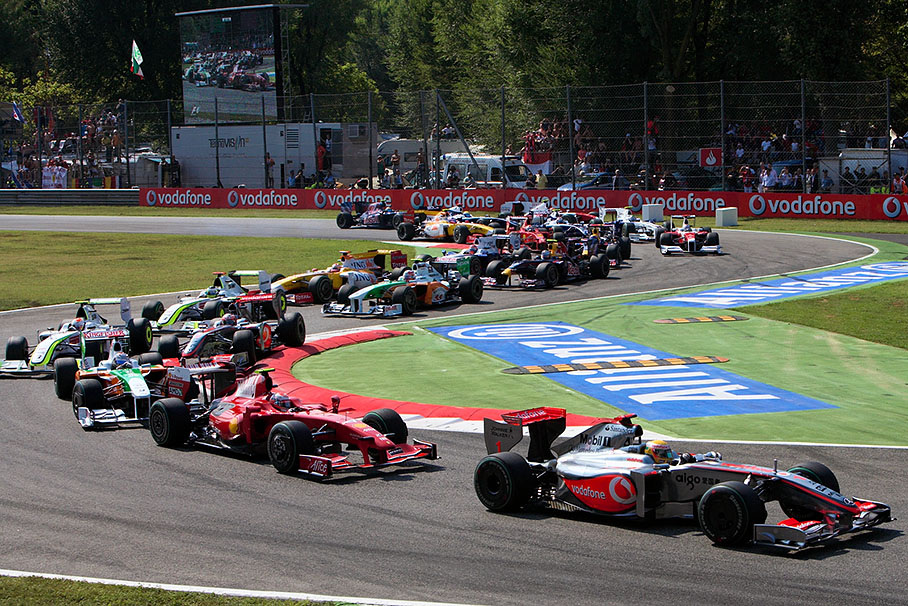 The start field jams through the first chicane, Variante Del Rettifilio, with Hamilton in the lead