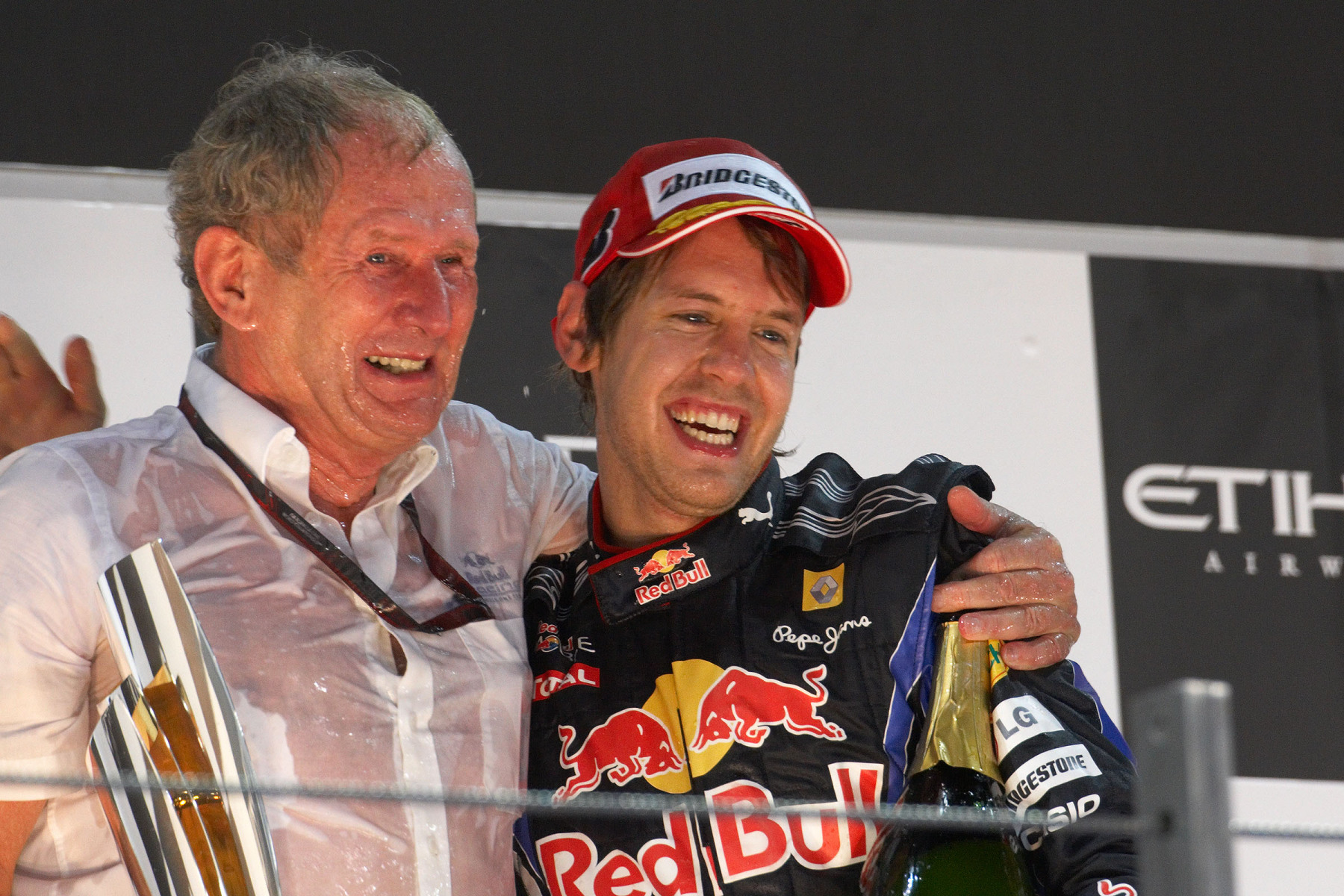 Red Bull's Helmut Marko celebrates on podium with race winner Sebastian Vettel