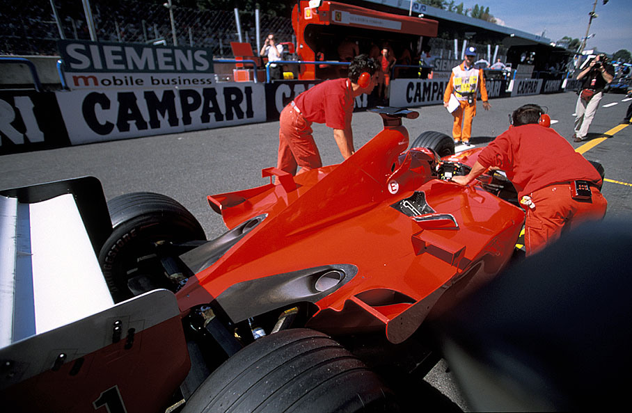 Michael Schumacher's car without liveries being pushed to FIA scrutineering