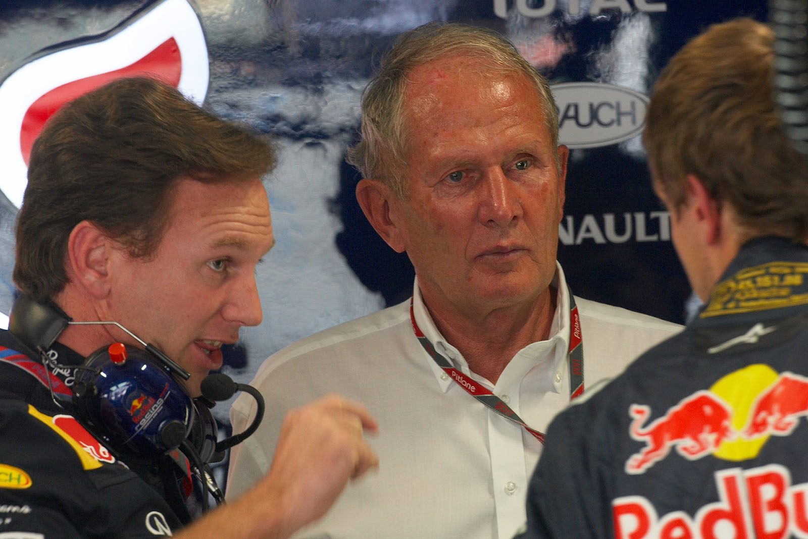 Red Bull advisor Dr. Helmut Marko listens to team boss Christian Horner and Sebastian Vettel in the pits
