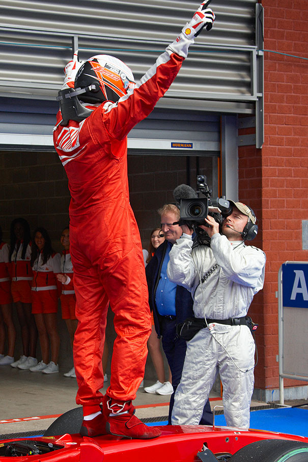 Race winner Kimi Raikkonen jumps on the Ferrari car in parc ferme and salutes towards the FOM TV camera, cheering about his first win for Ferrari in this season