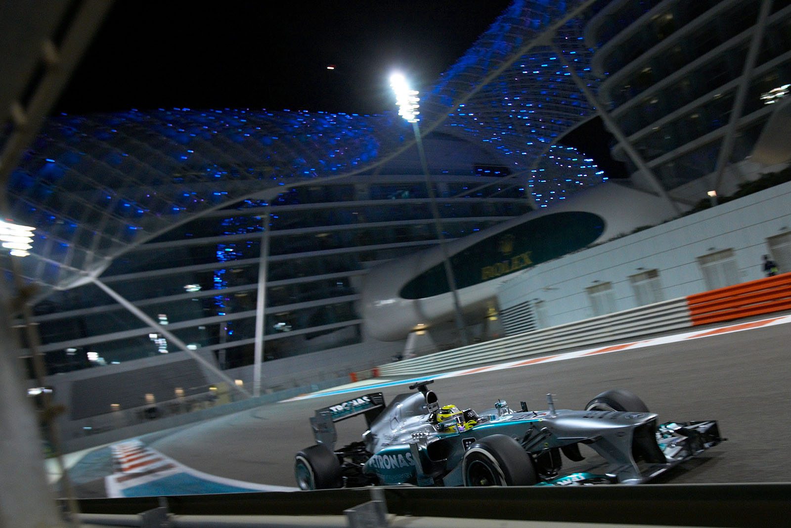 Nico Rosberg, Mercedes, passes the Yas Viceroy Hotel. The hotel has two towers linked together by a bridge of monocoque steel and glass.