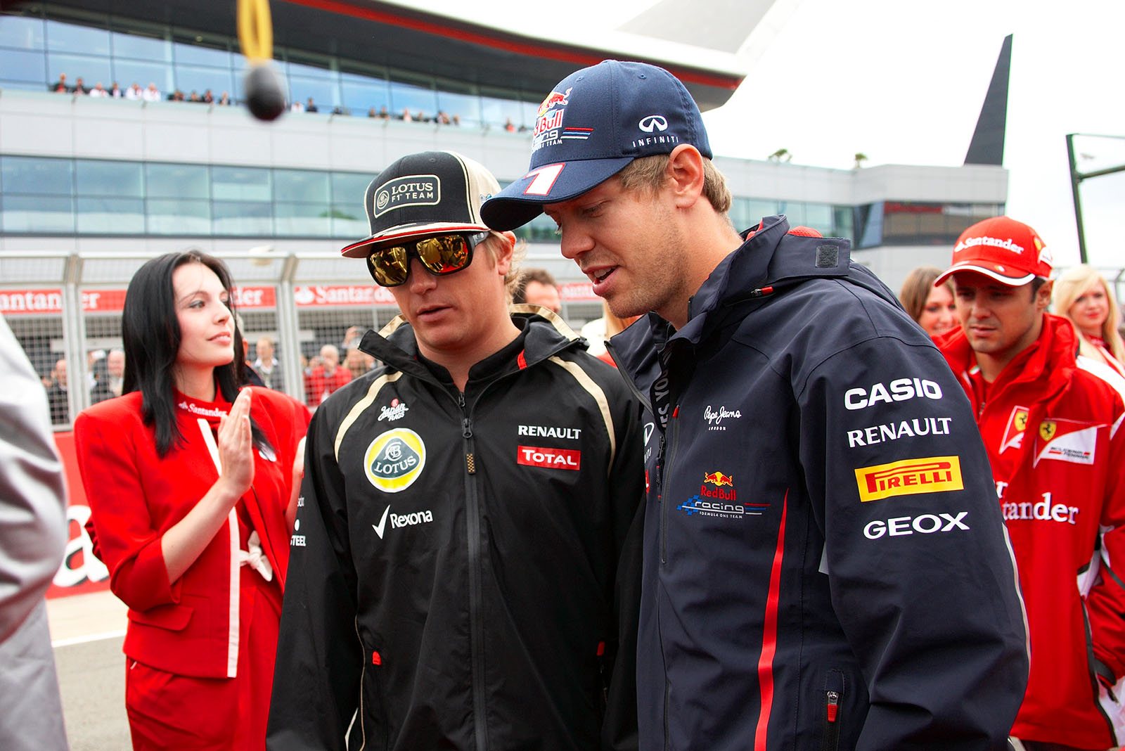 Kimi Raikkonen and Sebastian Vettel chat on their way to drivers parade
