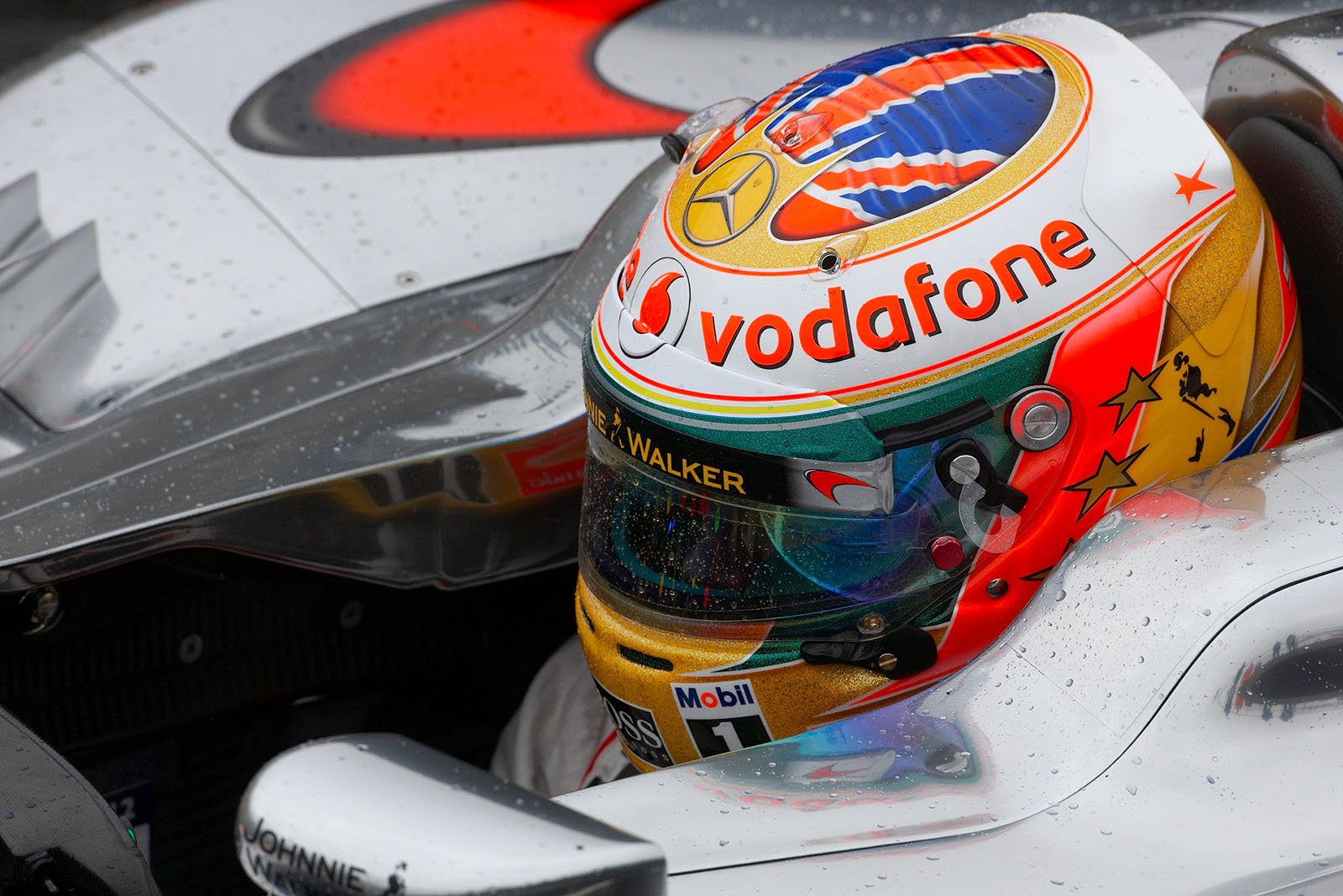 Lewis Hamilton, McLaren Mercedes, practises launches in the rain at pit lane exit